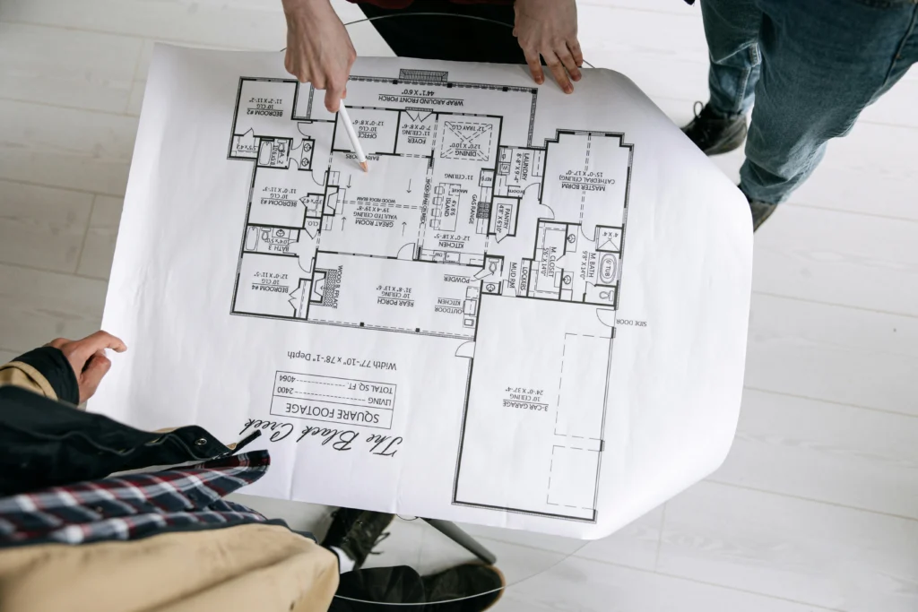 Builders reviewing project plans and architectural drawings